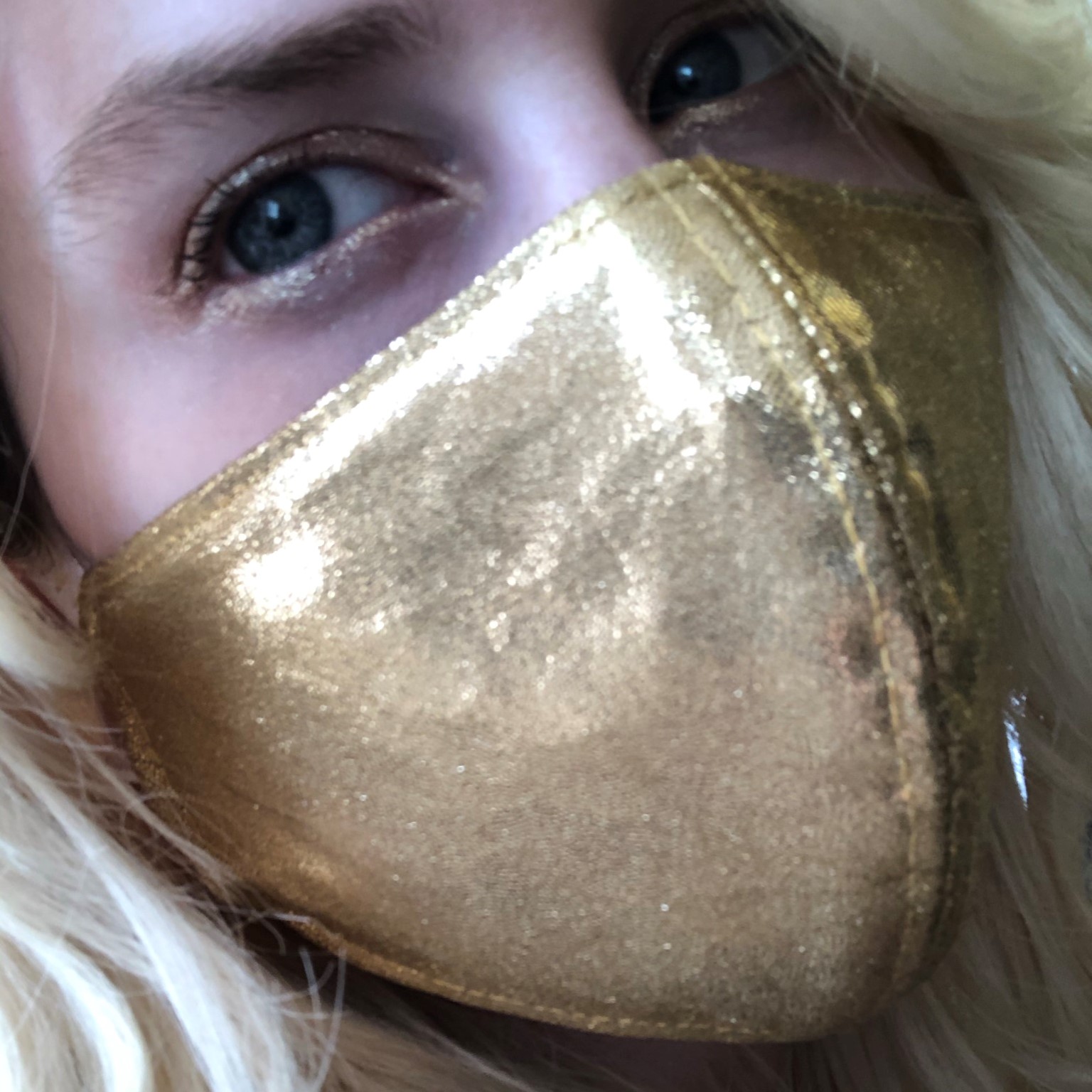 Dana wearing a gold mask