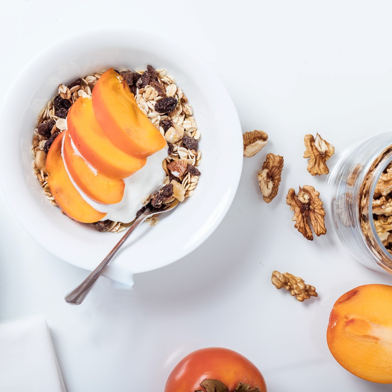 a bowl of cut peaches in granola